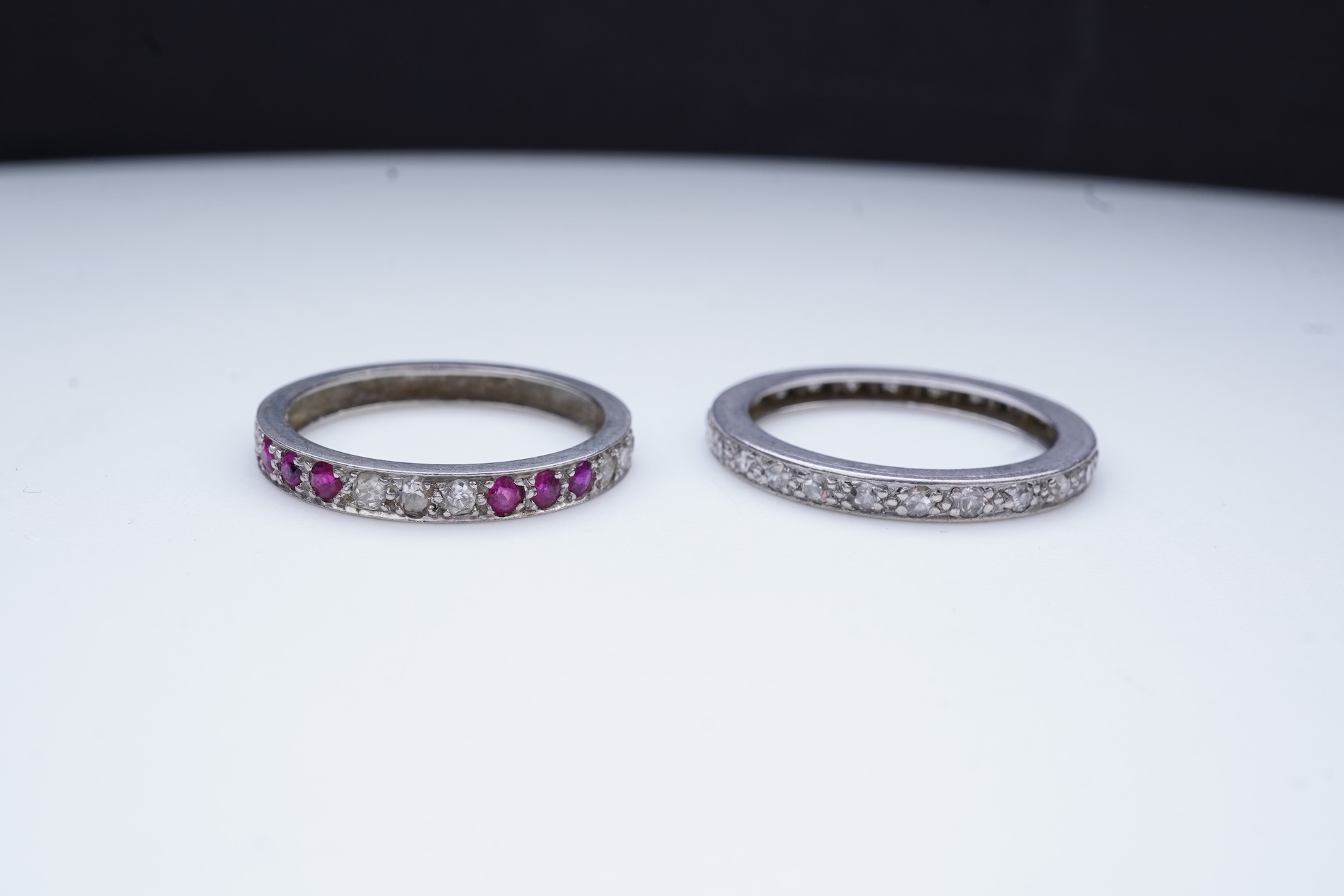 A diamond eternity ring and a ruby and diamond half eternity ring, mid 20th century